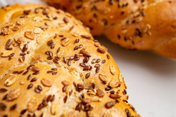 Various seeds on fresh bread texture, soft focus close up