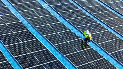 Worker Technicians are working to construct solar panels system on roof. Installing solar...