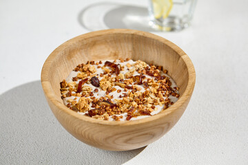Nutritious Smoothie Bowl with Dates, Wild Rice, and Granola in Wooden Bowl
