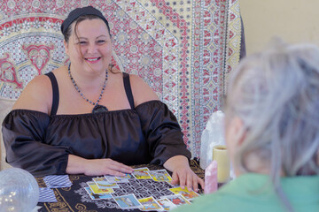 gypsy fortune teller dressed in black casting tarot cards
