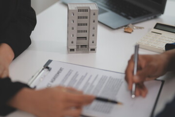 Sale representative offer house purchase contract to buy a house or apartment or discussing about...
