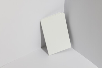 A blank book stands upright against a white background with copy space