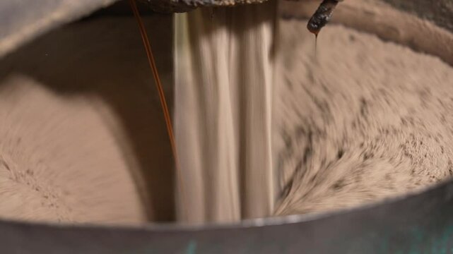 The process of preparing molding sand. metal casting process with red high temperature fire in metal part factory
