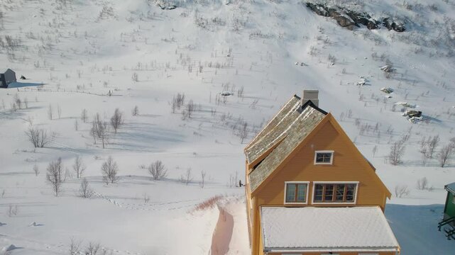 Myrdal snowy village in Norway, colorful house, aerial rise reveal mountain, winter magical travel in scandinavia, drone aerial