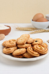Danish butter cookies on a white plate on a white table. Perfect for recipe, design element, article, or any commercial purposes.
