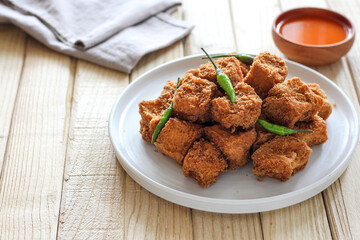 Sumedang tofu (tahu sumedang) on a wooden table. Perfect for recipe, article, catalogue, or any commercial purposes.