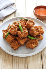 Sumedang tofu (tahu sumedang) on a wooden table. Perfect for recipe, article, catalogue, or any commercial purposes.
