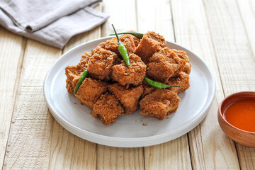 Sumedang tofu (tahu sumedang) on a wooden table. Perfect for recipe, article, catalogue, or any commercial purposes.