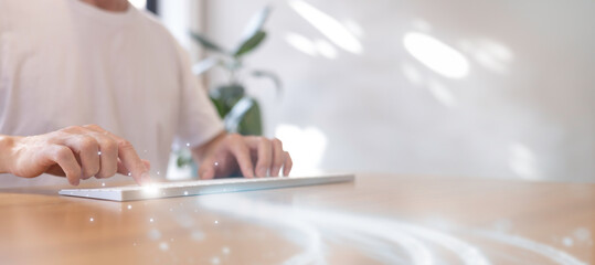 Man in casual ware working on laptop computer on office table.