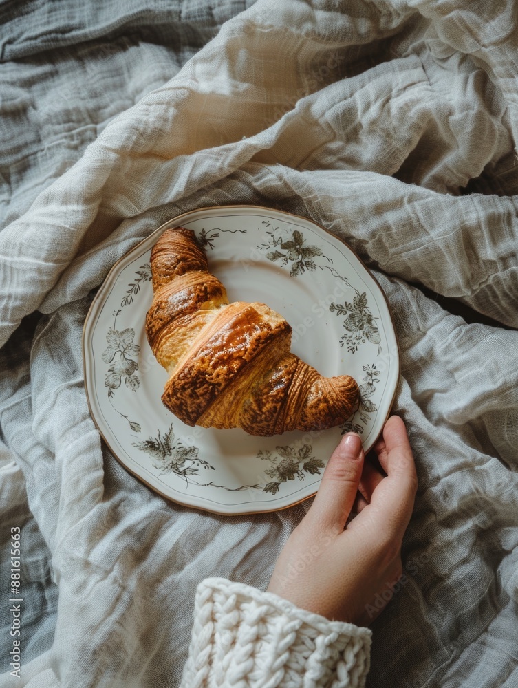 Sticker Person is holding plate with croissant on it