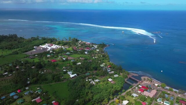 Teahupoo Tahiti pedestrian bridge judge tower aerial drone view French Polynesia coastline town village new Olympic 2024 sunny surf waves channel Point boats river Faremahora Pass Havae forward pan up
