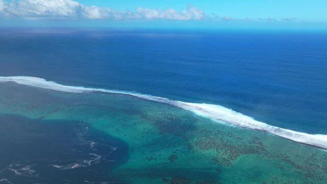 Teahupoo Tahiti aerial drone view French Polynesia point coast channel shallow coral reef wave surf break waves crashing aqua blue Pacific Ocean sea sunny Point Faremahora Pass Havae forward pan up