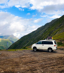 Tusheti, Georgia. Off-road car on lush mountain path. Caucasus Mountains view