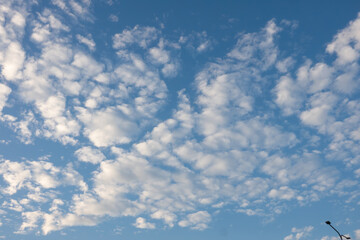 The sky is blue with many clouds. The clouds are white and fluffy. The sky is very clear and bright