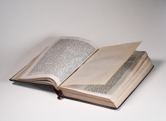 Open old book isolated on white