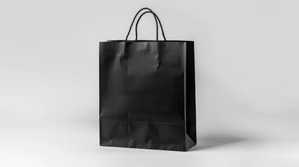 Paper shopping bag in black color against white background