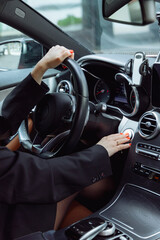 woman presses start stop button in car