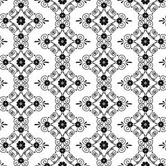 Seamless pattern with black swirls and small flowers on white background. Monochrome geometric pattern.