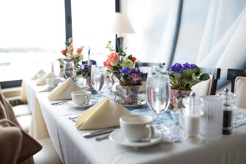 Elegant table setting with floral centerpieces for a bridal shower.