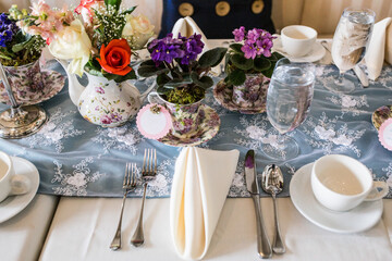 Floral teapot & teacup centerpieces on bridal shower table.