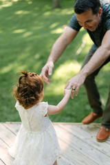Toddler girl playing with Dad