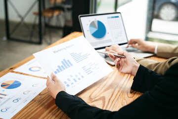 Two young Asian businesswoman discuss investment project working and planning strategy