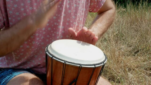 person playing drum outside close-up