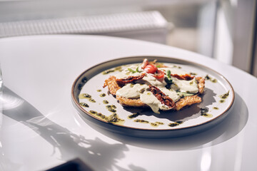 An attractive morning breakfast. Potato pancakes with white garlic sauce. Healthy breakfast in the restaurant. There is a place to copy. High quality photo