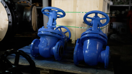 Close-up of blue industrial pipes. Production of industrial pipes for gas and oil pipelines. Blue pipe plugs are in stock before shipping.