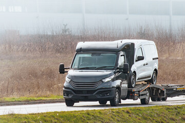 Commercial vans being transported on truck