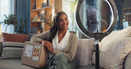 Indian woman, influencer and home on smartphone with box as gift for social media and live...