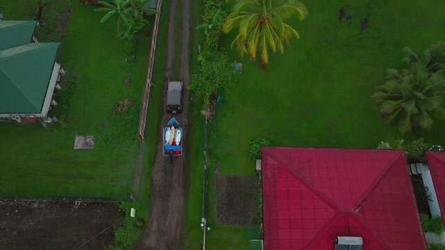 Jeep boat trailer sunrise early morning Teahupoo Tahiti French Polynesia birdseye view aerial drone end of the road Olympic venue surf village town buildings coastline Pass Havea reef