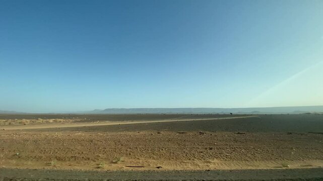 View of desert steppe from car window in Zagora Morocco