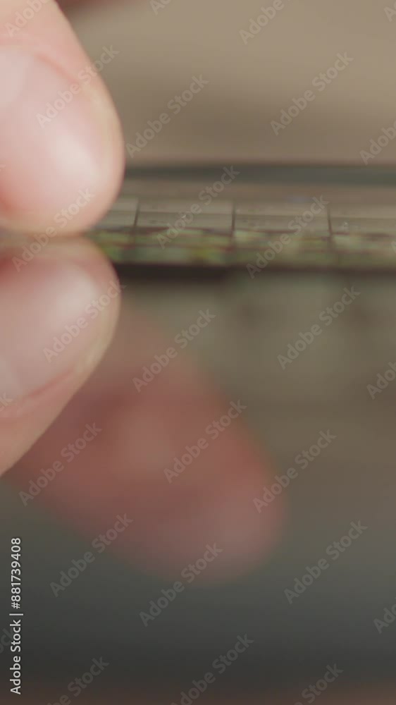 Aufkleber The closeup photo depicts hands using a smartphone indoors, interacting with various apps and browsing the internet. This device offers connectivity and access to online content for the user