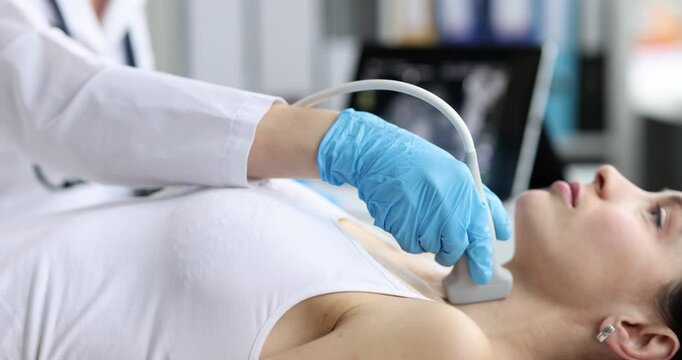 Doctor in diagnostic center makes ultrasound of thyroid gland. Thyroid ultrasound concept