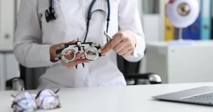 Ophthalmologist shows glasses for selection of lenses in optics. Selection and selection of glasses for farsightedness and myopia and astigmatism concept