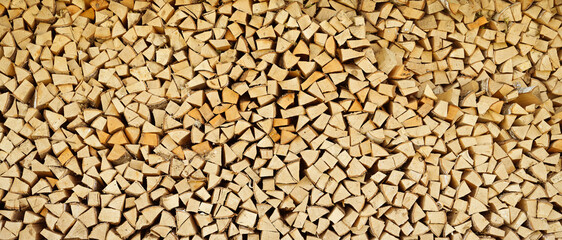 Firewood. logs stacked on top of each other. Wood texture background. heating in winter