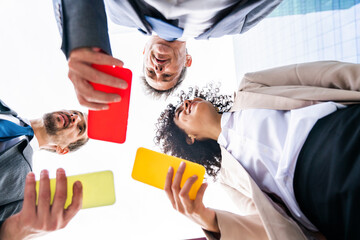 Multiracial group of business people bonding outdoors - International business corporate team wearing elegant suit meeting in a business park