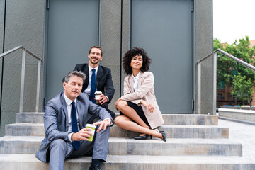 Multiracial group of business people bonding outdoors - International business corporate team...