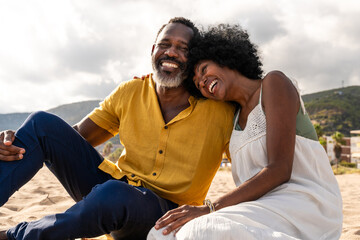 Beautiful mature senior black couple of lovers dating at the seaside - Married african middle-aged...