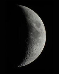 Half moon with moon craters on a dark space background high definition © Daan