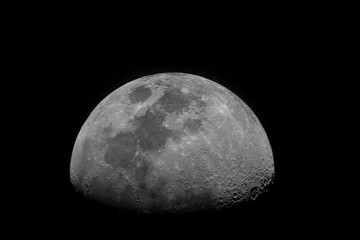 Crescent moon with moon craters on a dark space background