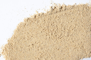 Ground dry ginger root on a white background