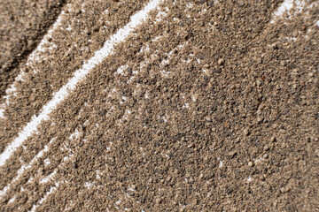 Abstract striped brown ground black pepper background top view. Creativity in cooking.