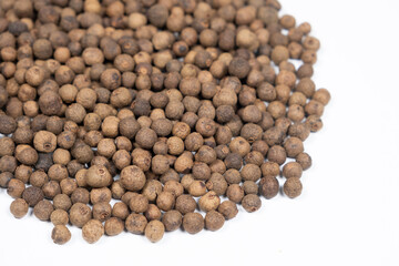 Black peppercorns close-up on white background