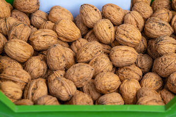 green container filled with walnuts