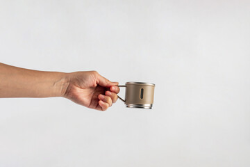 Stainless steel cup in hand isolated on white background