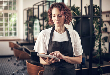 Beauty, work and woman with tablet in hair salon for job, planning and reading online appointment....
