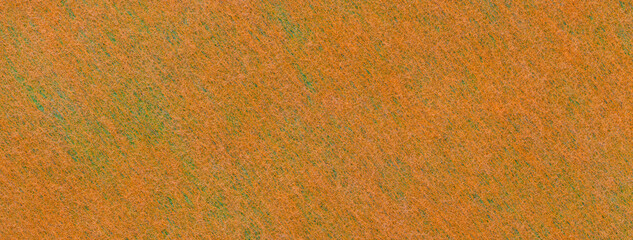 Texture of orange and green color background from felt textile material, macro. Vintage ginger fabric