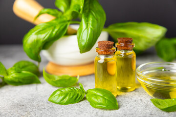 Basil essential oil on a textured wooden background. Basil essential oil and fresh leaves. Aromatherapy. Aroma oil. Medical herbs. Alternative medicine. Place for text. Copy space.